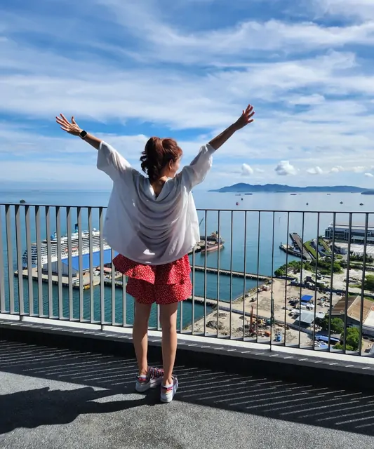 Enjoying a sense of freedom at a lookout point overlooking the harbor.