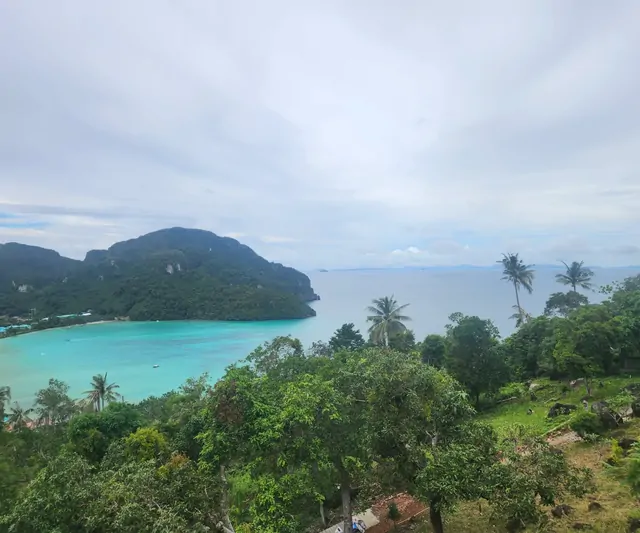 Lush tropical forests and the ocean seen from the island lookout.