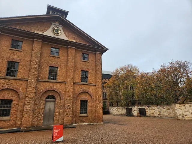 Red brick buildings and autumn leaves at the Hyde Park Barracks.