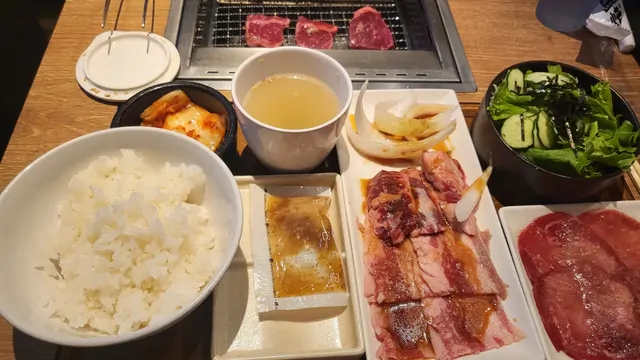 Yakiniku meat set with rice, soup, and salad on the table.