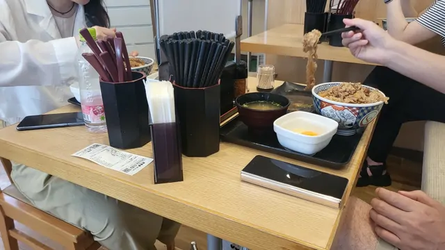Gyudon beef bowl served with miso soup and a raw egg.
