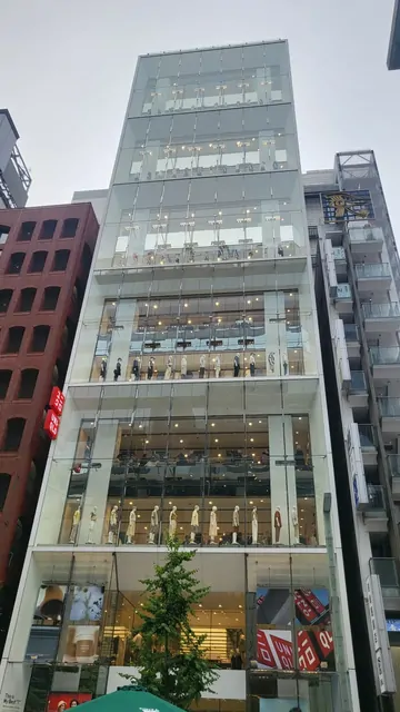 A glass-walled fashion mall building in the Ginza district.