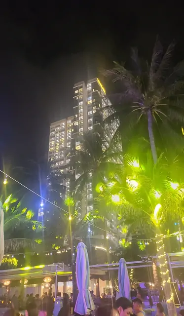 The city skyline and palm trees viewed from an outdoor bar.