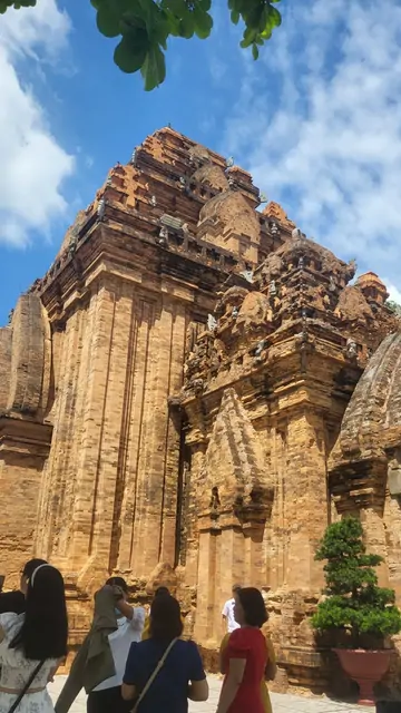 Visitors looking up at the ancient Hindu towers of Po Nagar.