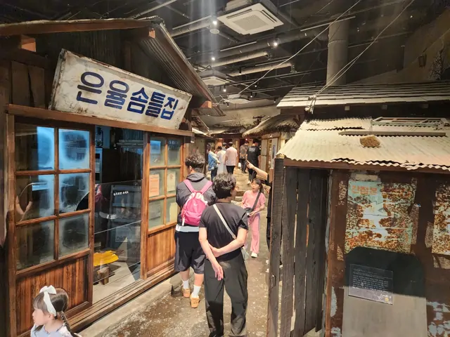Visitors walking through a retro-style alleyway exhibition.
