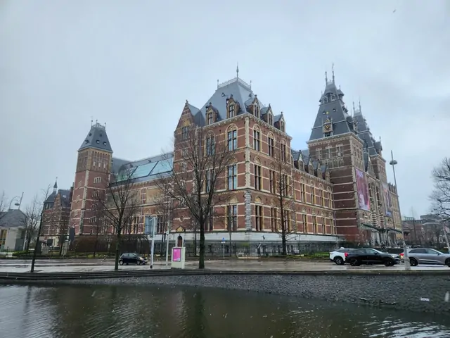 The Gothic exterior of the Rijksmuseum under a cloudy winter sky.