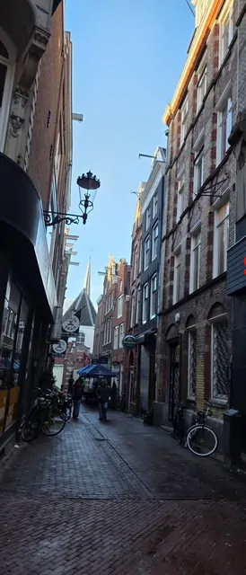 A narrow brick alley in the old city with bicycles lined up.