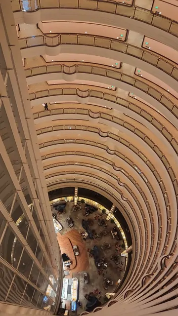 The stunning spiral architecture of the Jin Mao Tower's interior atrium.