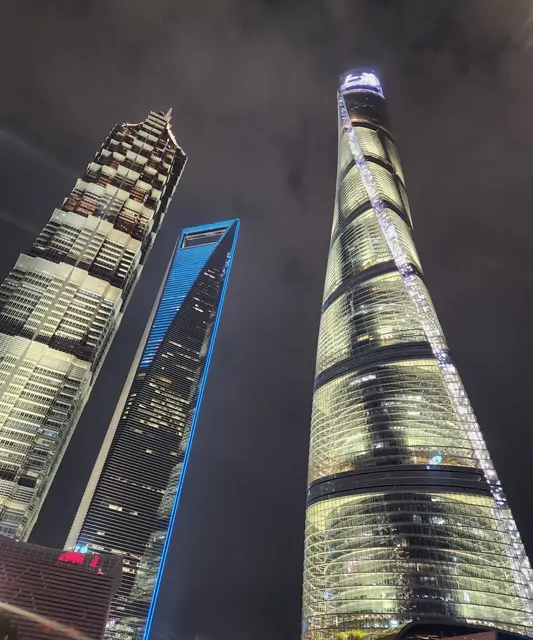 The trio of giants: Jin Mao, World Financial Center, and Shanghai Tower at night.