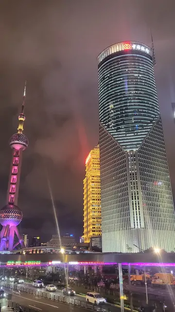 The glowing lights of the Oriental Pearl Tower and surrounding skyscrapers.